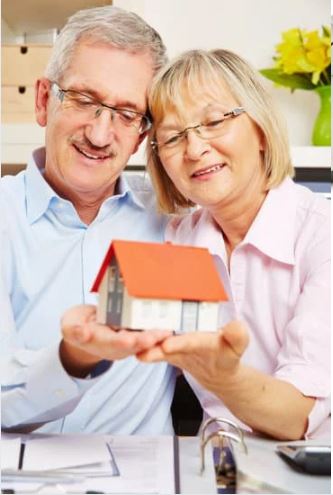 Imagen de pareja con maqueta de casita
